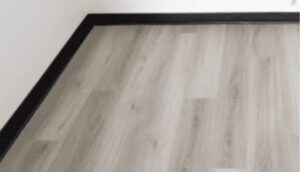 Modern bathroom flooring with light tile and wicker basket accent in Ottawa home