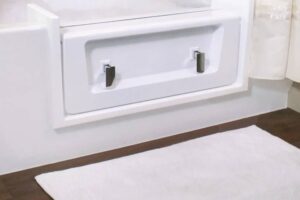 White bathtub fitted with a watertight step-in door insert
